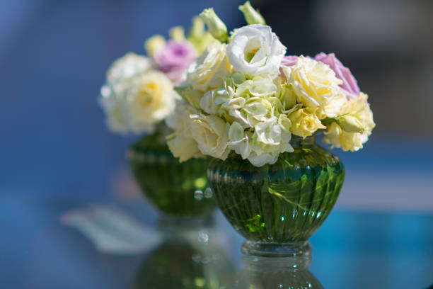 two small rose bouquets in vase - defocused
