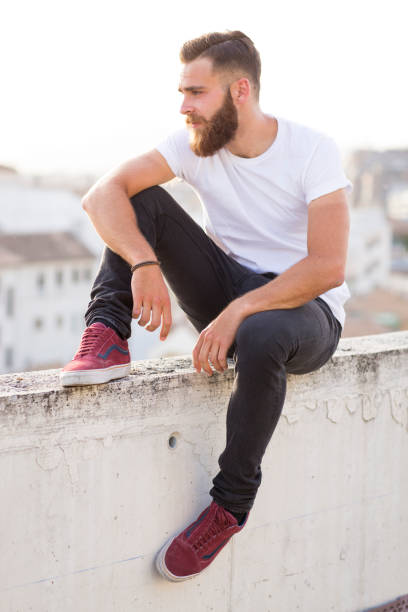 istock Bearded man sitting in the wall. 647742806