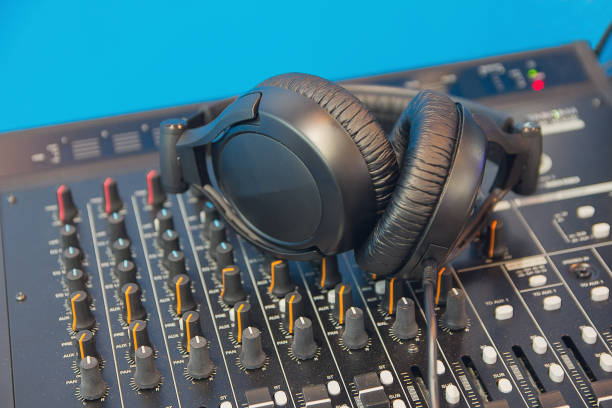 istock DJ Mixer with knobs and black headphones. Music 647745774
