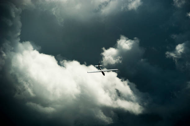 istock Unidentifiable acrobatic glider gliding across the cloudy sky 647746184