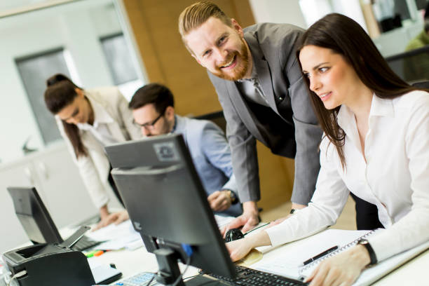 istock Group of young business people at office 647746670