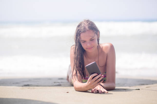 istock beautiful young woman on the beach 647752886