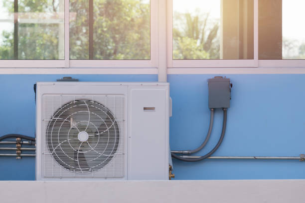 istock air condition compressor outside the office building 647753164