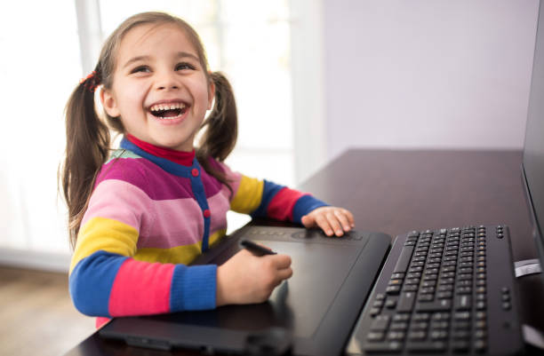 istock Little Girl Drawing On Graphic Tablet 647753736