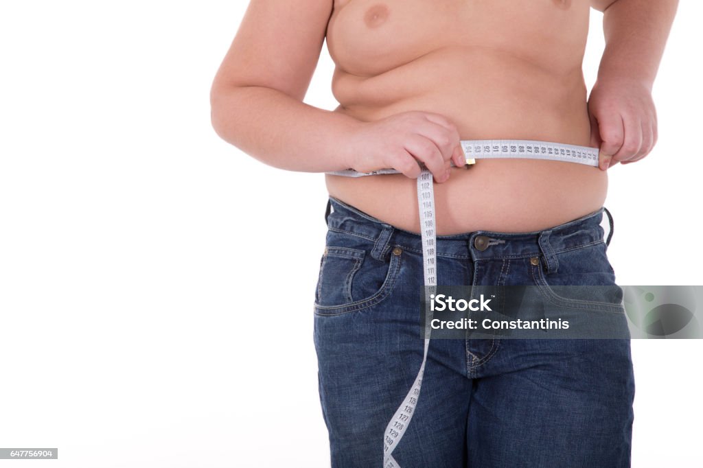 Fat boy measuring his belly Child Stock Photo