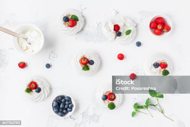 Meringues Pavlova Cakes With Strawberry And Blueberry Stock Photo - Download Image Now