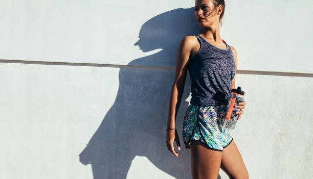 istock Sporty woman relaxing after running exercise 647769432