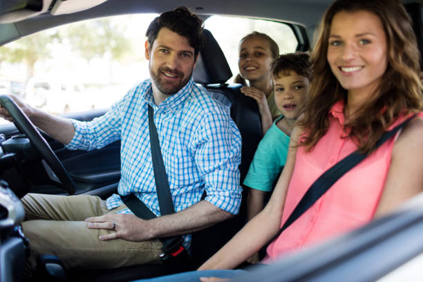istock Happy family sitting in car 647769806
