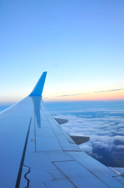 istock Clouds and sky as seen through window of an aircraft 647769860