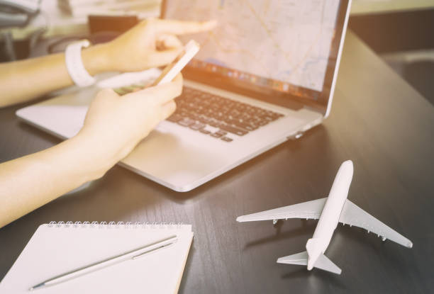 istock Traveler is using Internet GPS map on Laptop and Smartphone to plan is vacation trip 647770316