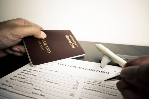 Tourist is filling a visa application form stock photo