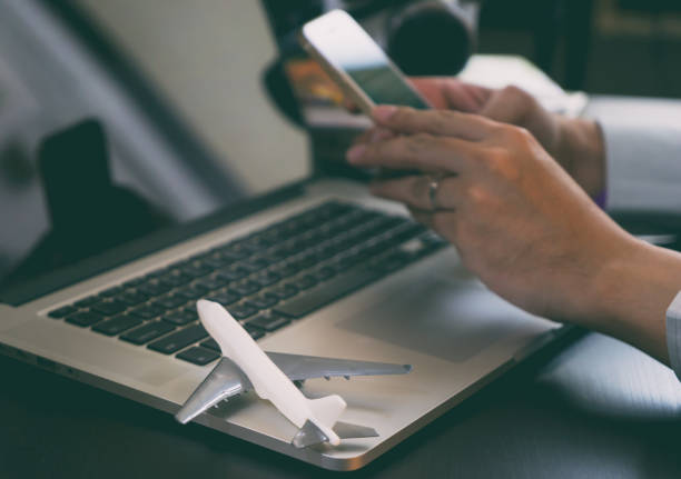 istock Business traveler using his phone to book his trip 647770470