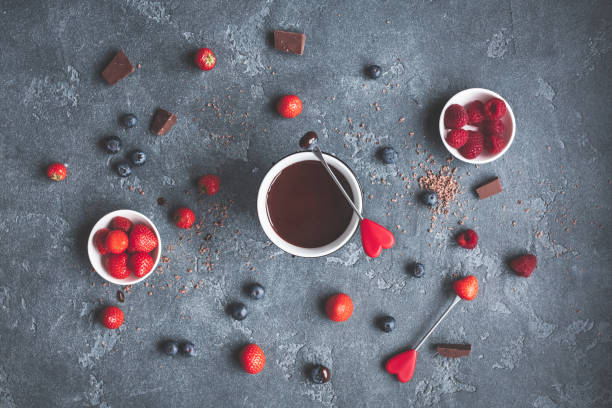 istock Chocolate fondue with fresh berries on dark background 647772682
