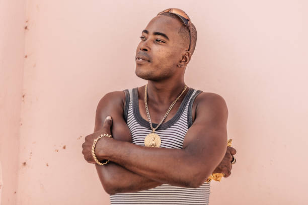 istock young afro–caribbean cuban man in front of purple wall 647773016