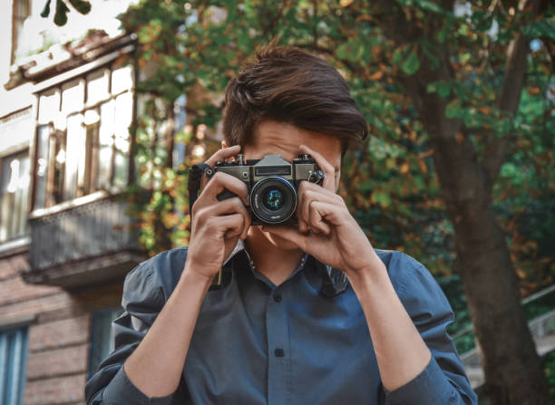istock Hipster guy photographer with retro camera 647777536