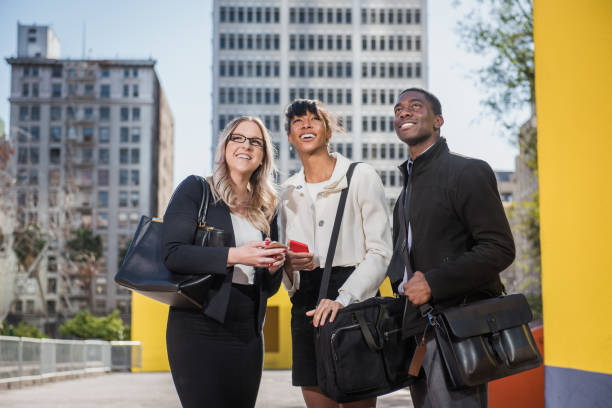 istock Three Multi Ethnic Millennials in business attire with mobile devices in Downtown Los Angeles 647777716