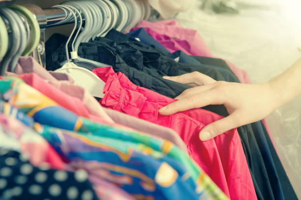istock Clothes hanging on the rack in the store 647780634