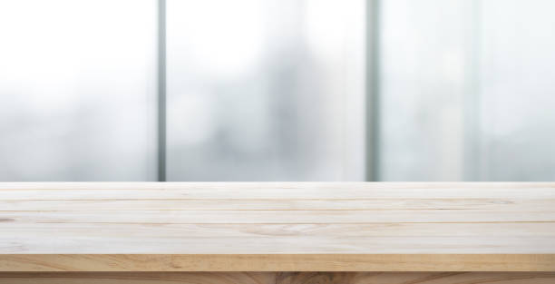 istock Wood table top on glass wall abstract background. 647783932