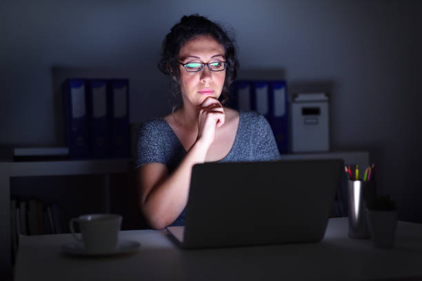 istock Woman working late at office 647786442