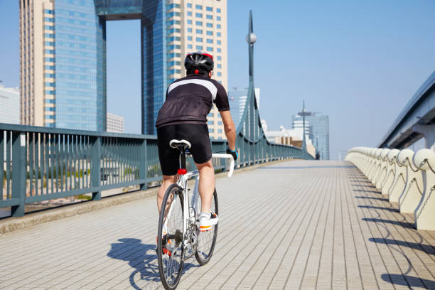 istock Japanese man cycling on the bridge 647787208