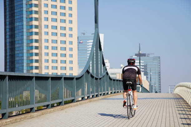 istock Japanese man cycling on the bridge 647787212
