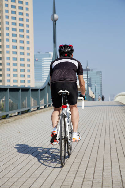 istock Japanese man cycling on the bridge 647787262
