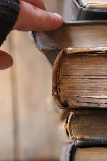 istock education idea, student or scientist takes the book on a shelf in the library, soft focus 647794804