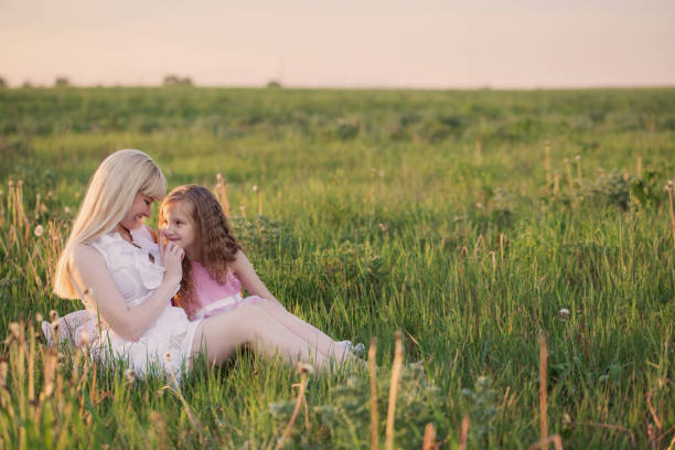 istock mother and  daughter on meadow 647795020