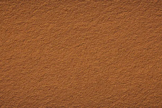 Red clay court tennis background texture. Tennis court close-up of gravel surface