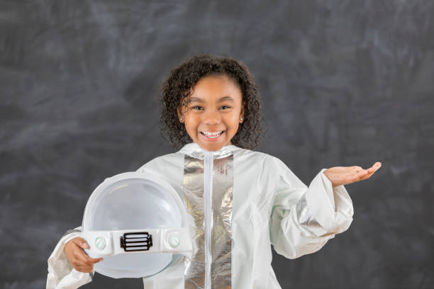 istock Confident elementary schoolgirl wears astronaut costume 647798834