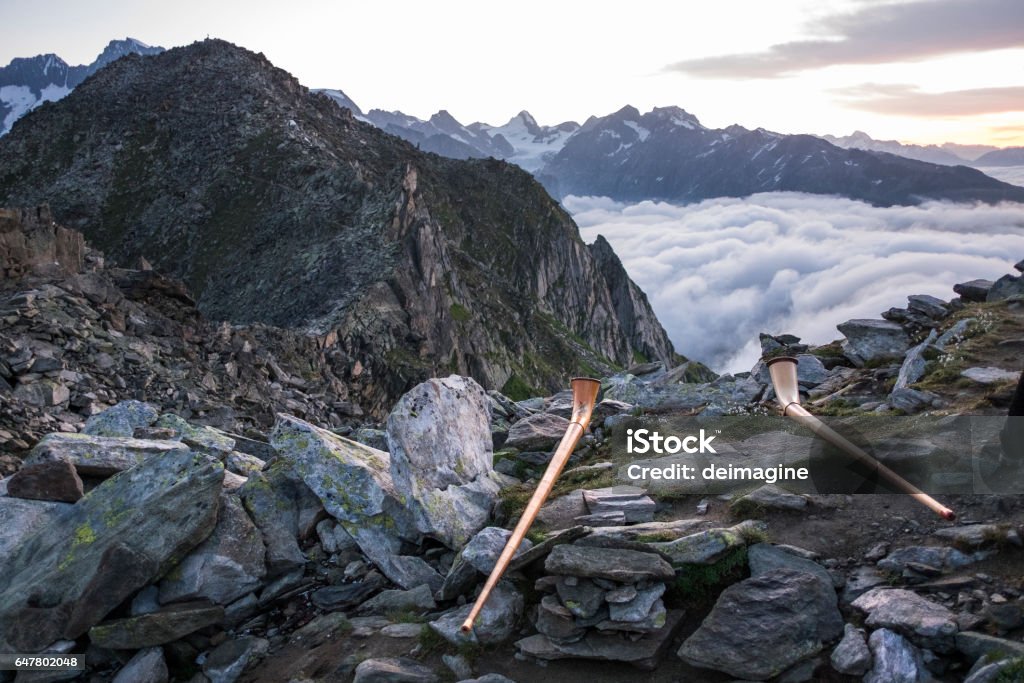 Traditional swiss horn on top of Mount Eggishorn during sunrise. The Eggishorn is a mountain in the Bernese Alps, canton of Valais, Switzerland. Mountain Stock Photo