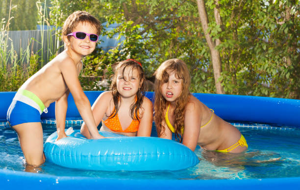 istock Three happy kids having fun at tub in the yard 647802102