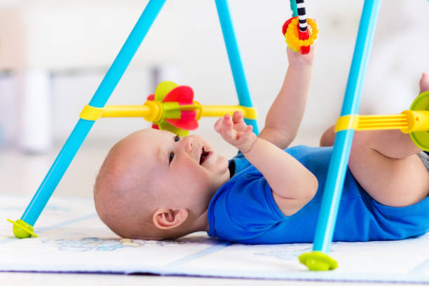istock Baby boy on play mat. Child playing in gym. 647808634