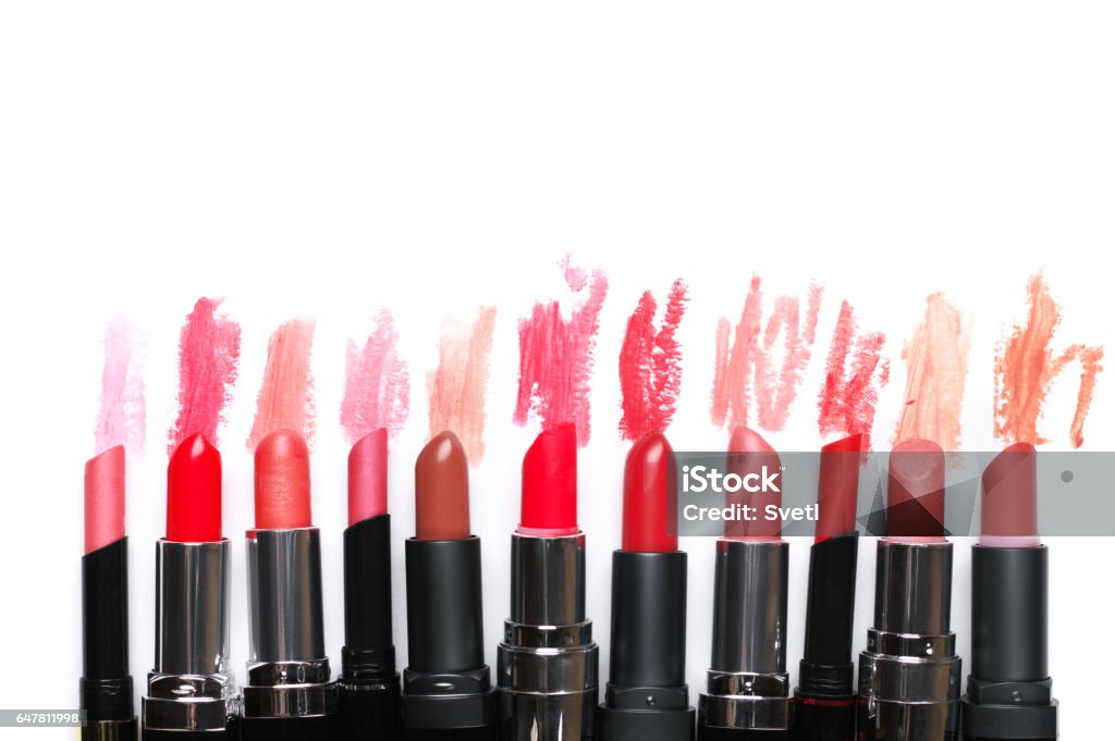 Set of colorful lipsticks Set of colorful lipsticks with smudged samples partially isolated on white background. Top view point. Lipstick Stock Photo