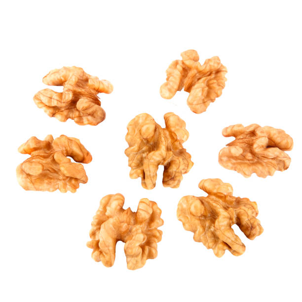istock Walnuts in closeup isolated on white background 647816078