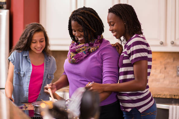 istock Multi-ethnic family at home cooking together in kitchen. 647819382