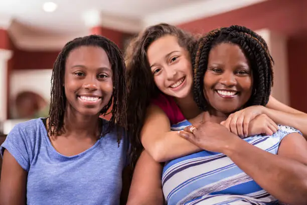 Photo of Multi-ethnic, foster care family at home.