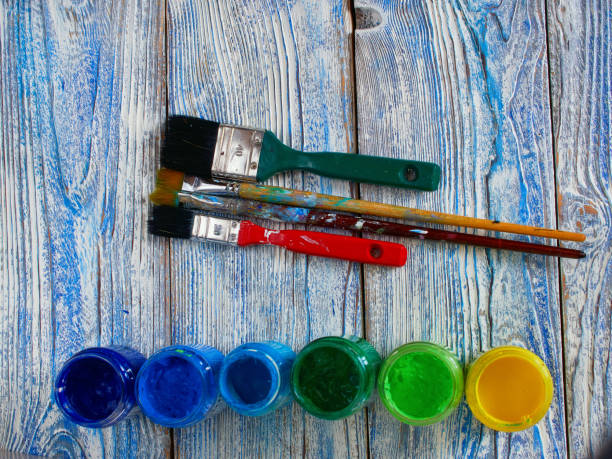 istock Acrylic paints and colored brushes on an authentic background of hand made with copyspace 647820406