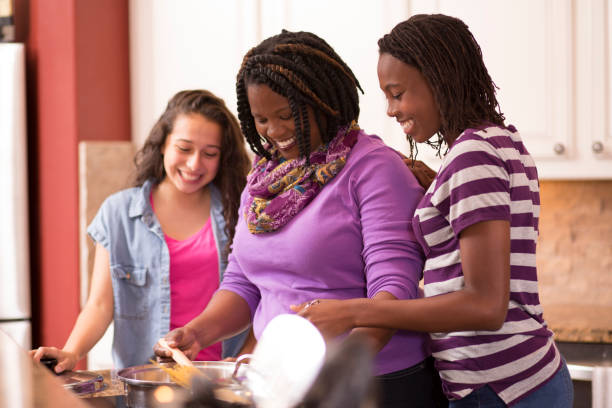 istock Multi-ethnic family at home cooking together in kitchen. 647820796