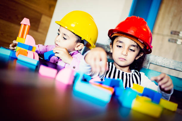 Real sister with brother playing in builders