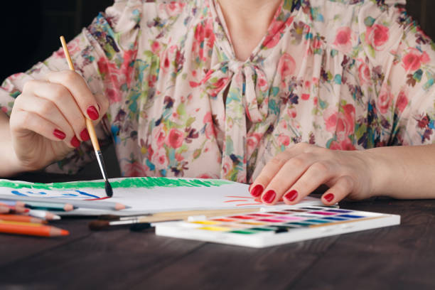 istock Woman drawing house 647830110