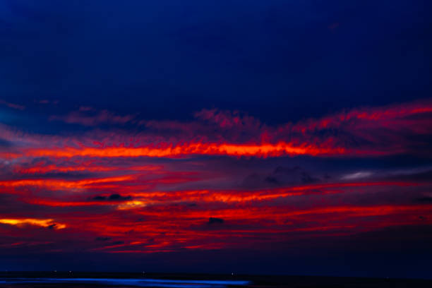 fiery sunset at night, clouds blur in motion.