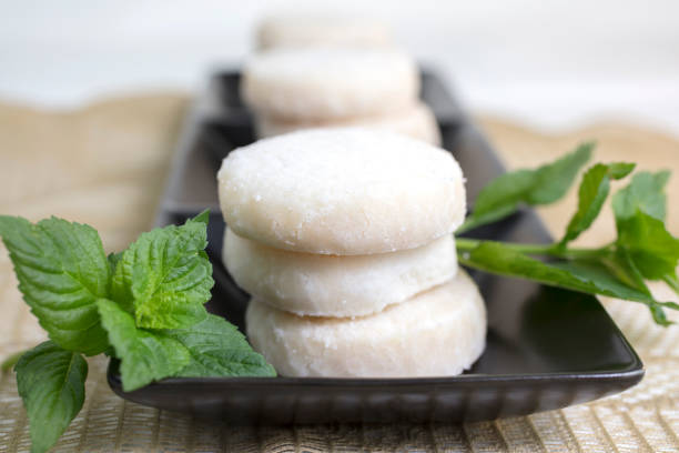 istock Lemon and Vanilla Shortbread Cookies Plated On Black Ceramic and Lace Doily 647833616
