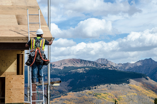Vail, Colorado, USA - October 2, 2015: Carpenters work on a new sledding attraction at the top of Vail Mountain which overlooks the Colorado Rockies and Vail Pass. The village was established and built as the base village to Vail Ski Resort, with which it was originally conceived and is the third largest ski mountain in North America. Vail attracts wealthy visitors, many of whom, who build and purchase vacation homes and condominiums near the ski slopes. Taken at the summit of Vail Mountain in Vail, Colorado near the Eagle Bahn Gondola.