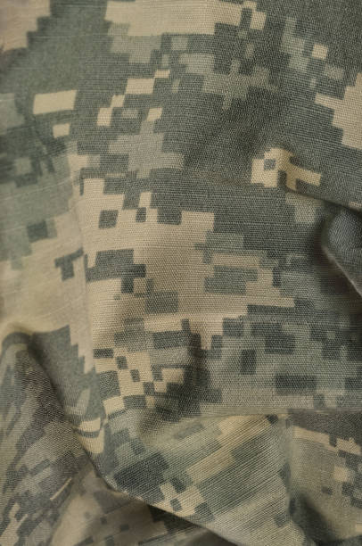 istock Universal camouflage pattern, army combat uniform digital camo, USA military ACU macro closeup, rip-stop fabric texture background, crumpled, wrinkled, foliage green, yellow desert tan, urban grey NYCO, nylon, cotton, vertical 647834074