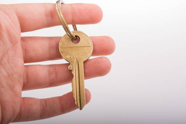 istock Hand holding a  golden color key 647839422