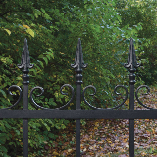 istock Forged black decorative wrought iron fence closeup 647842566