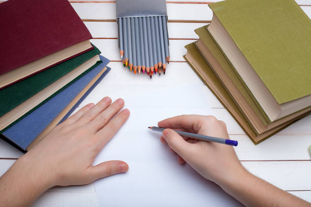 istock pencil in hands draw on paper. 647842750