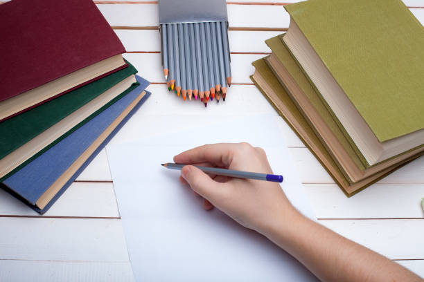 istock pencil in hands draw on paper. 647845114