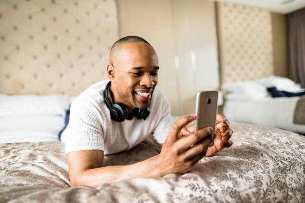 istock man relaxing on the bed listening music 647845456